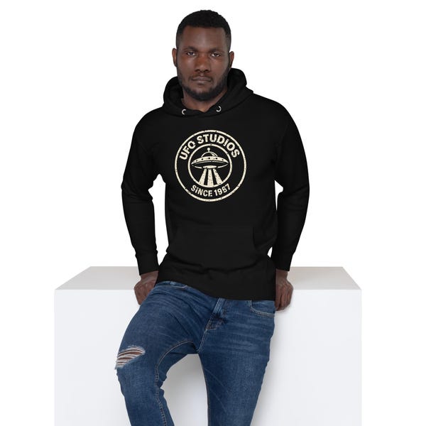 Black UFO Studios premium pullover hoodie with distressed circular flying saucer seal